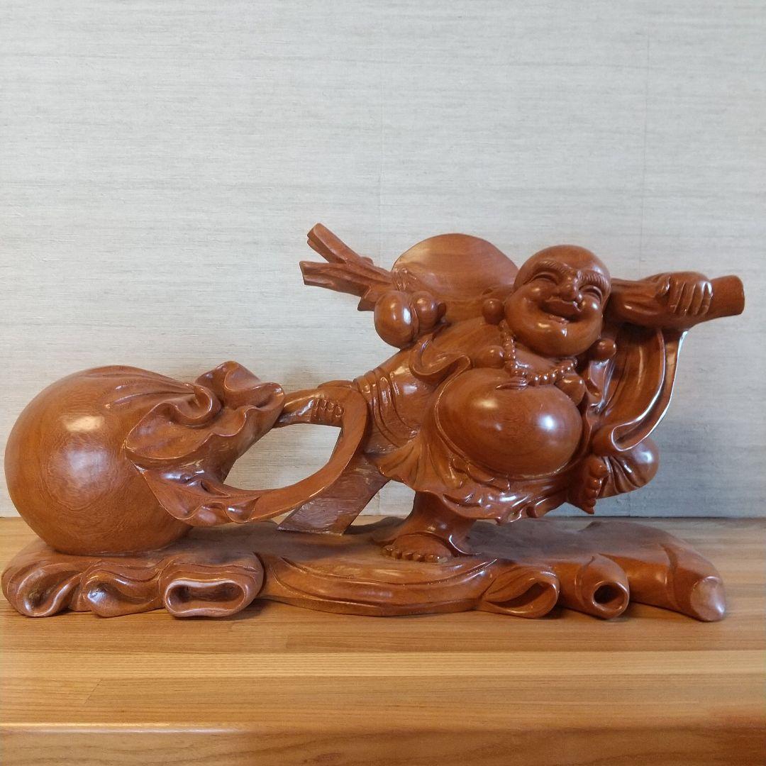 木製布袋の置物で一枚木彫りの高さ25cm長さ52cm幅15cm重さは約５キロです